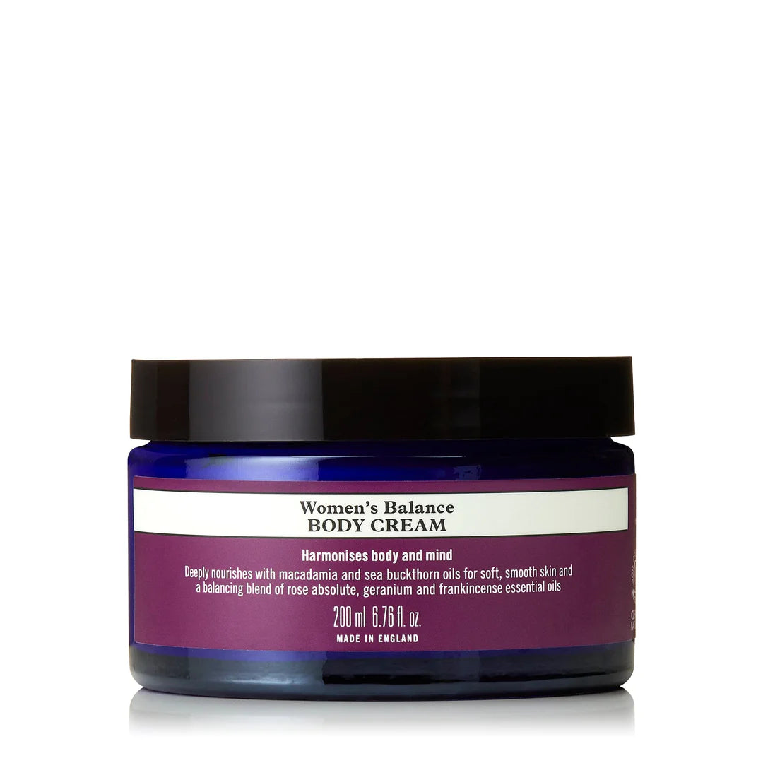 A jar of Neal's Yard Remedies Women's Balance Body Cream with a purple label and black lid.