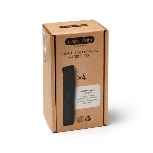Box of four active charcoal water filters by black+blum on a white background