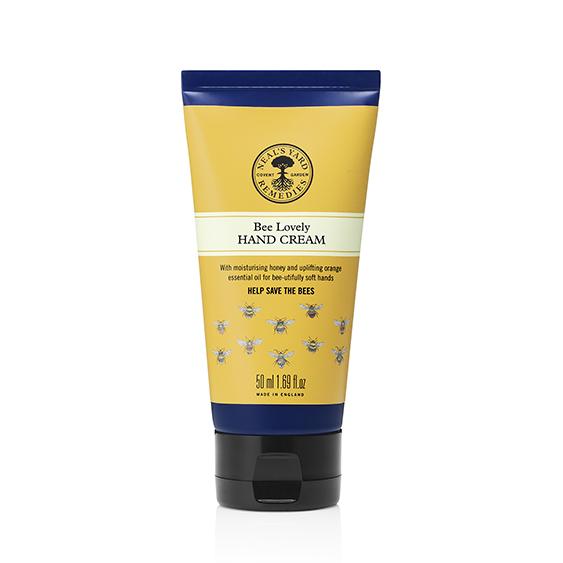 Tube of Bee Lovely Hand Cream with yellow and blue packaging, featuring illustrations of bees and text that promotes bee friendliness.